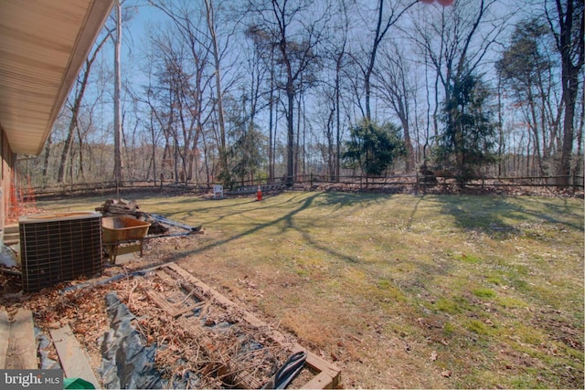 view of yard featuring fence and central AC unit