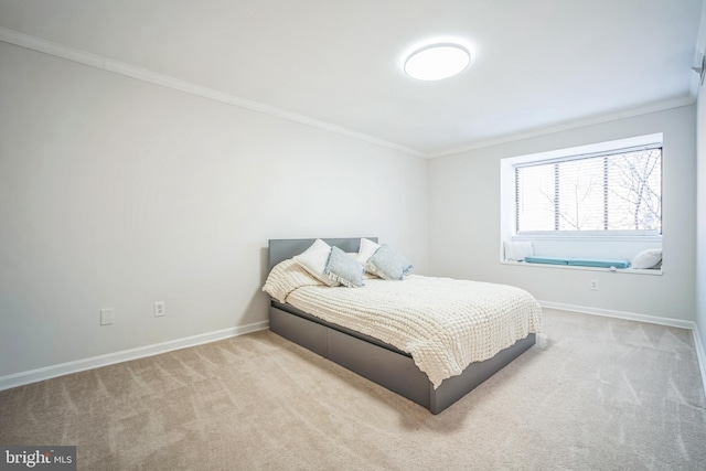 bedroom with carpet floors, baseboards, and crown molding