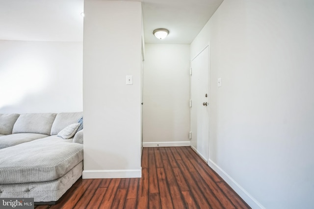 interior space with baseboards and wood finished floors