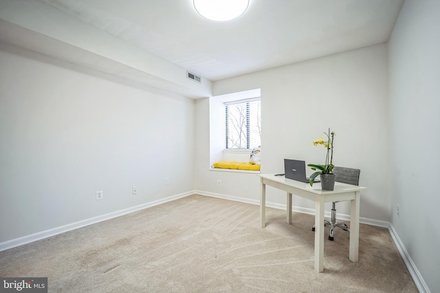 carpeted office with visible vents and baseboards