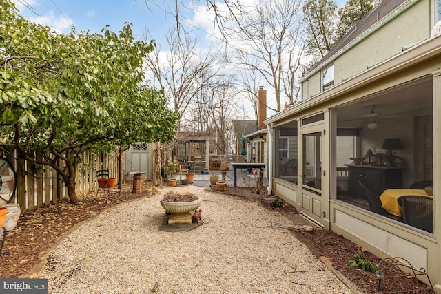 view of yard featuring a fenced backyard and a sunroom