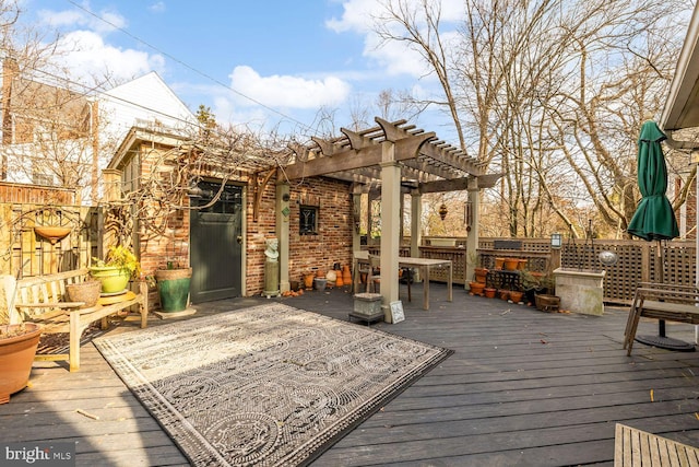 wooden deck featuring fence and a pergola