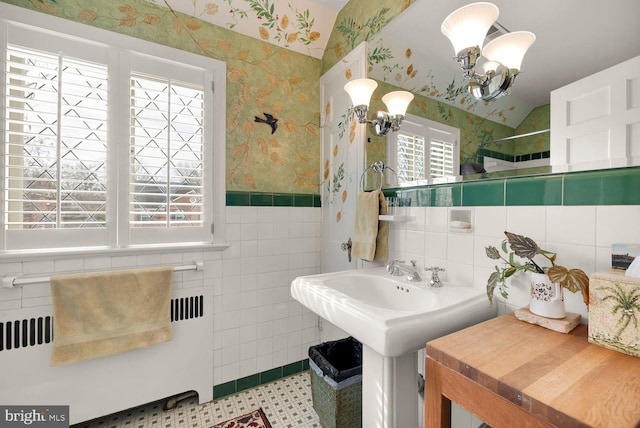 bathroom with a notable chandelier, tile walls, wainscoting, radiator, and wallpapered walls