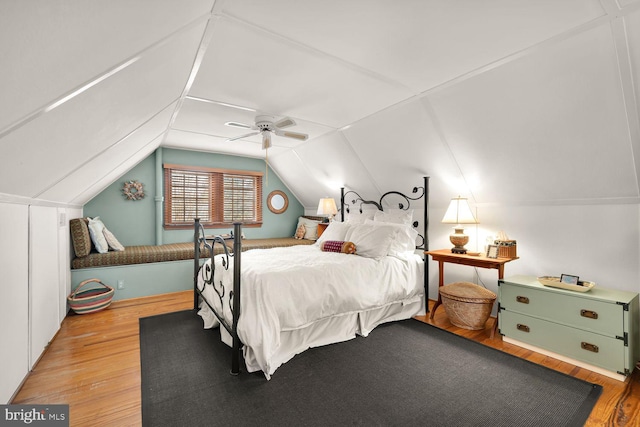 bedroom featuring ceiling fan, vaulted ceiling, and wood finished floors