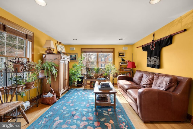 living area featuring light wood-style floors and recessed lighting