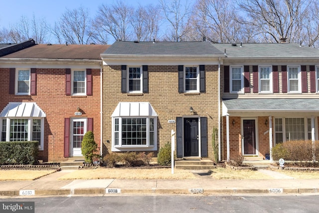 townhome / multi-family property featuring entry steps and brick siding