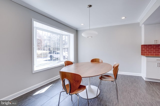 dining room with baseboards, recessed lighting, wood finished floors, and crown molding