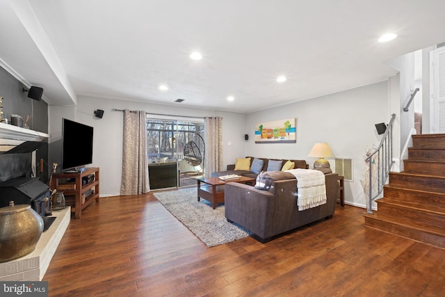 living room featuring visible vents, crown molding, stairs, recessed lighting, and wood finished floors