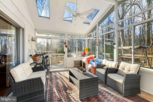 sunroom / solarium featuring lofted ceiling with skylight and ceiling fan