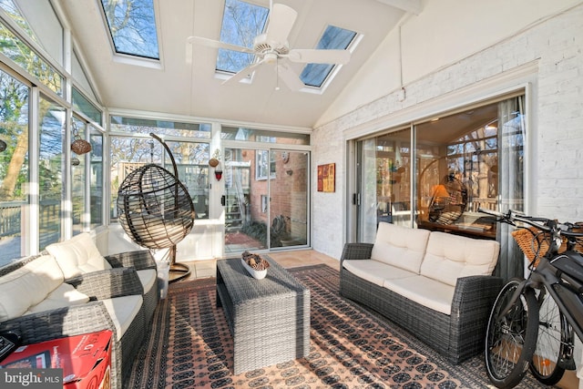 sunroom featuring lofted ceiling with skylight and a ceiling fan