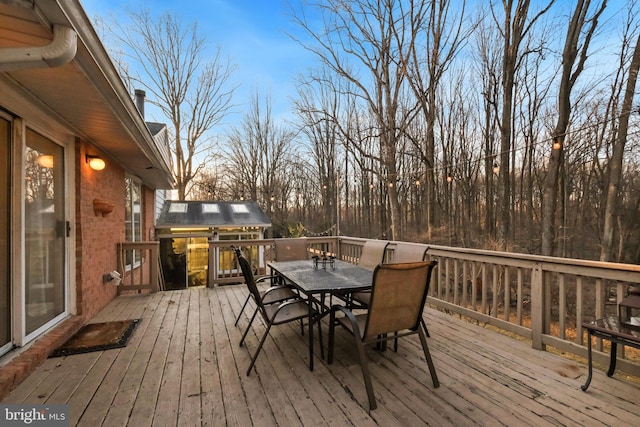 wooden terrace with outdoor dining space