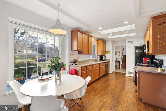 kitchen featuring visible vents, recessed lighting, light countertops, dishwasher, and dark wood-style flooring