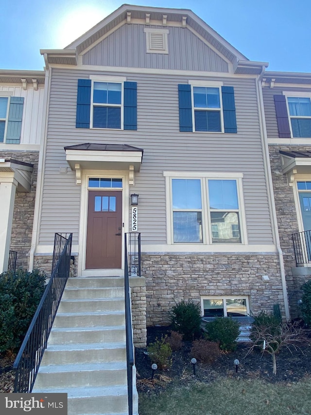 view of property featuring stone siding