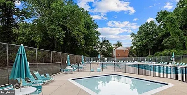 pool featuring a patio area and fence