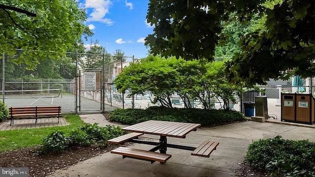 view of home's community featuring a gate and fence