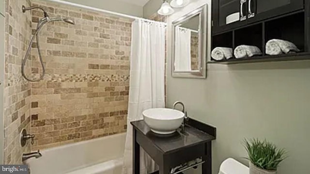 full bathroom featuring toilet, shower / tub combo, and vanity