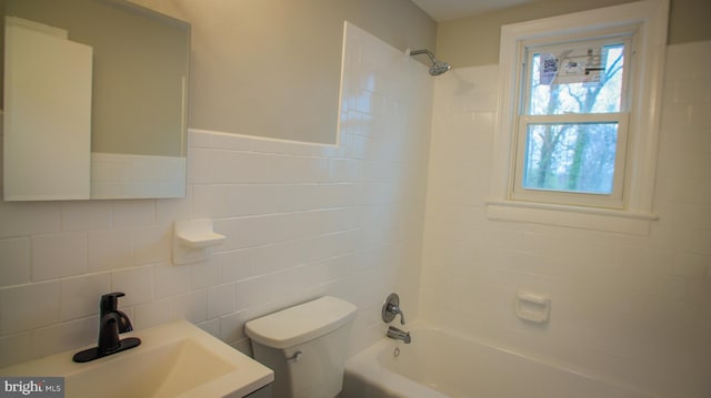 full bathroom with toilet, vanity, tile walls, and shower / bathing tub combination