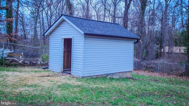 view of shed featuring fence