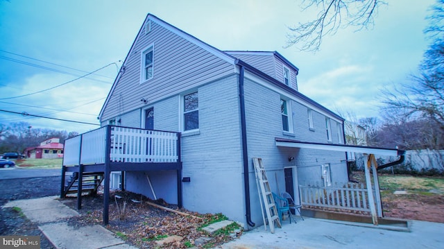 view of home's exterior with stairway and a wooden deck