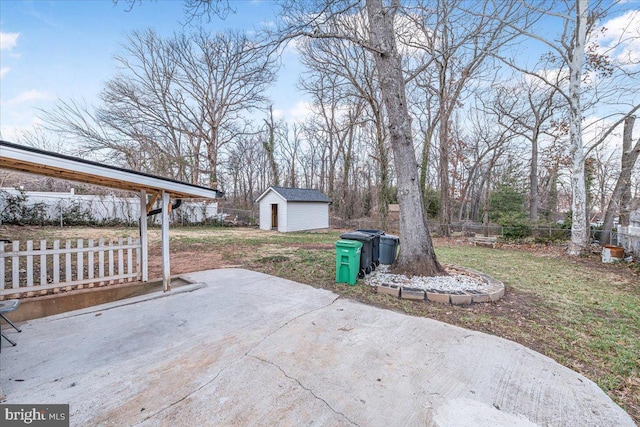 view of patio with a storage shed, an outbuilding, and fence