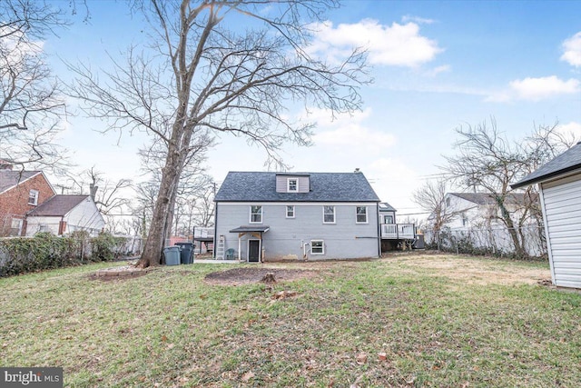 back of house with a yard and fence