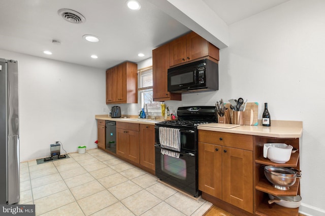 kitchen with visible vents, recessed lighting, a sink, black appliances, and light countertops