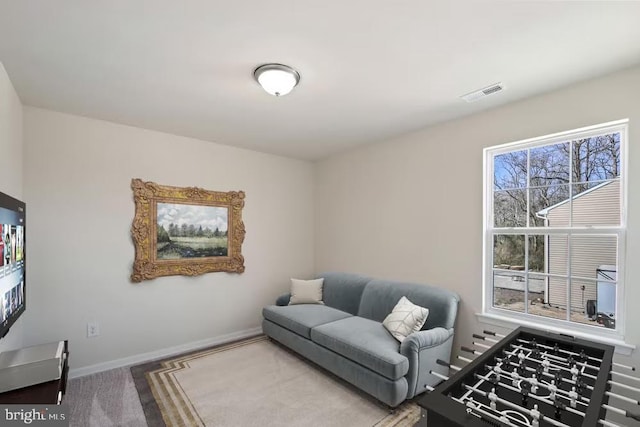 living room with baseboards and visible vents