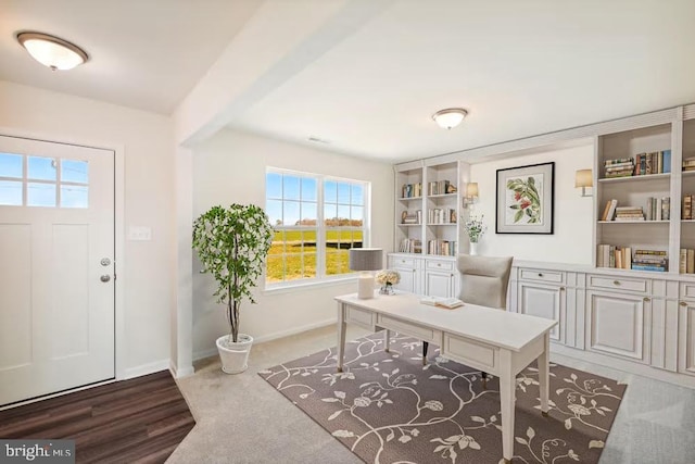 office featuring baseboards and beam ceiling