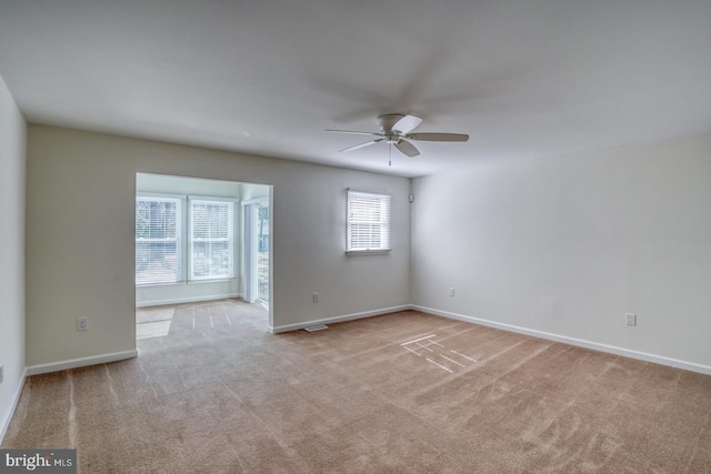 unfurnished room with ceiling fan, carpet flooring, and baseboards