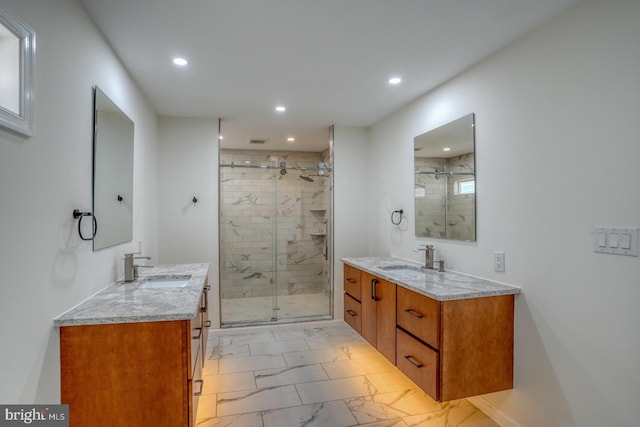 bathroom featuring marble finish floor, a stall shower, and a sink