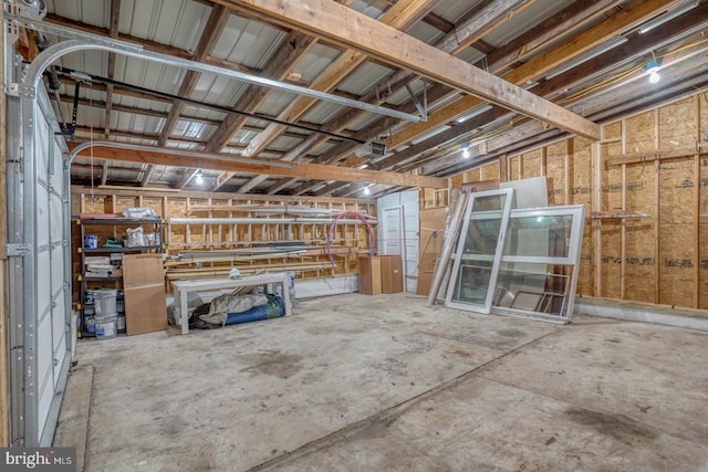 interior space featuring a garage and unfinished concrete floors