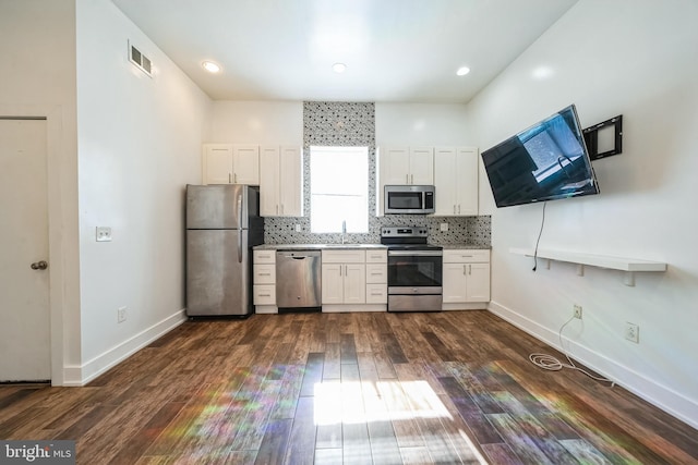 kitchen featuring visible vents, white cabinetry, light countertops, appliances with stainless steel finishes, and decorative backsplash