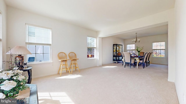 sitting room with a notable chandelier and light colored carpet