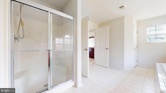 full bath featuring a shower stall, visible vents, and baseboards