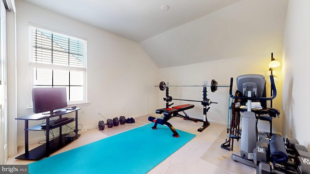 workout area featuring lofted ceiling, baseboards, and light colored carpet