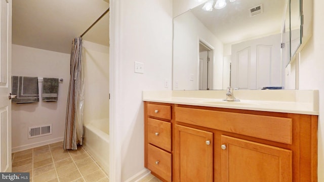 full bathroom with shower / tub combo, tile patterned flooring, visible vents, and vanity