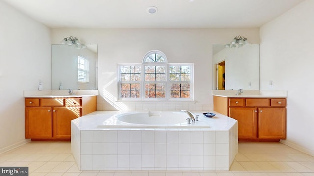 bathroom featuring two vanities, a garden tub, a sink, and tile patterned floors