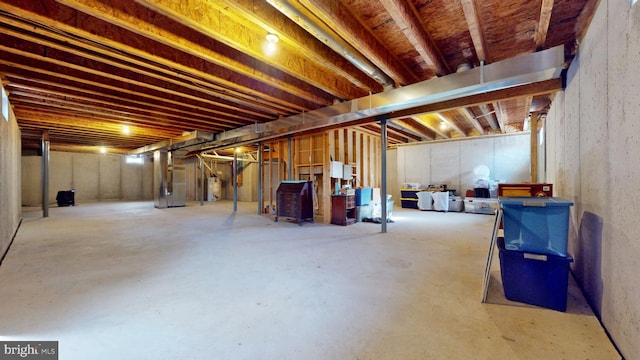 unfinished basement featuring water heater and heating unit