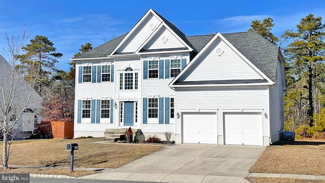 view of front of home with driveway, a garage, fence, and roof with shingles