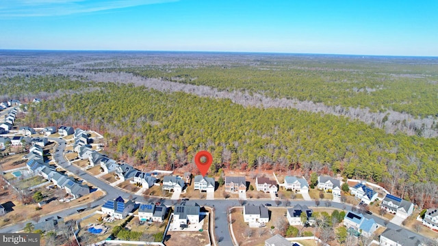 drone / aerial view with a forest view and a residential view