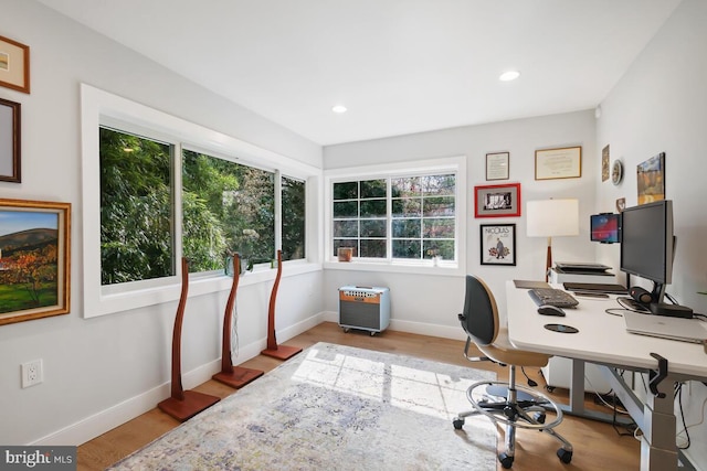 office area with wood finished floors, baseboards, and a wealth of natural light