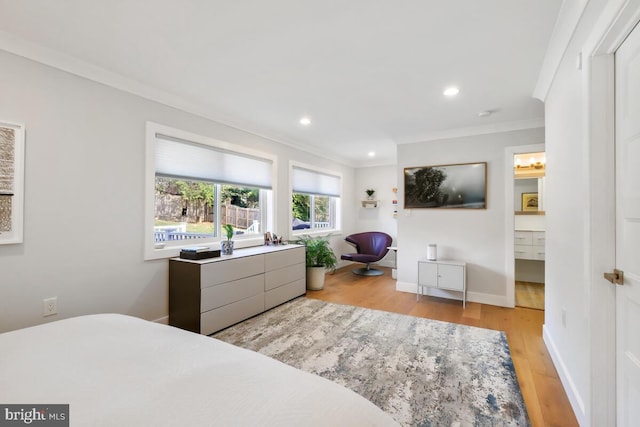 bedroom with light wood-type flooring, ornamental molding, recessed lighting, connected bathroom, and baseboards