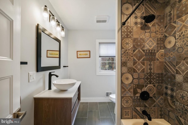 bathroom with visible vents, baseboards, toilet, and vanity