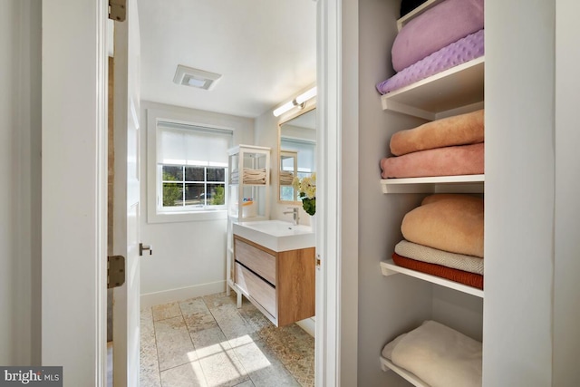 bathroom featuring vanity and baseboards