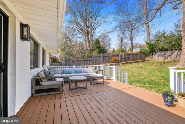 deck with a fenced backyard, an outdoor hangout area, and a yard