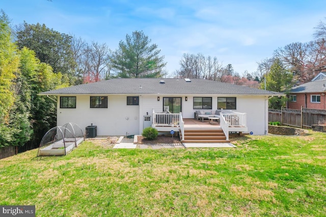 back of property featuring a deck, a yard, fence, and cooling unit