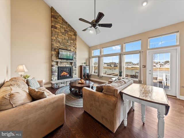 living room featuring a fireplace, a healthy amount of sunlight, hardwood / wood-style floors, and a ceiling fan