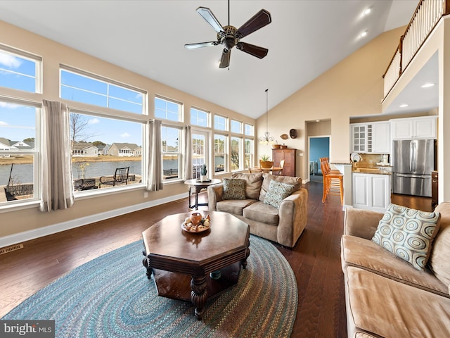 living room featuring visible vents, high vaulted ceiling, wood finished floors, baseboards, and ceiling fan
