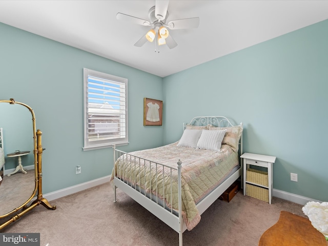 carpeted bedroom featuring baseboards and ceiling fan