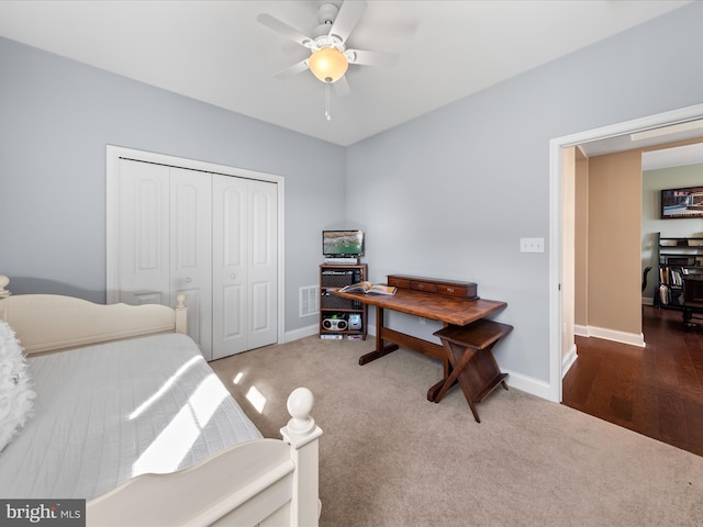 carpeted bedroom featuring a closet, baseboards, visible vents, and ceiling fan